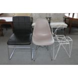 A leather dining chair on metal legs,