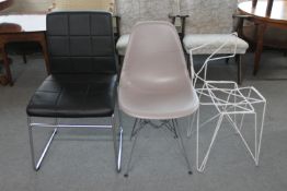A leather dining chair on metal legs,