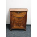 An antique continental walnut cupboard fitted with a drawer on bun feet CONDITION