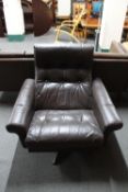 A mid 20th century Danish brown leather swivel armchair on a chrome base