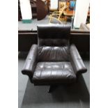 A mid 20th century Danish brown leather swivel armchair on a chrome base