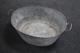 A mid 20th century galvanized twin handed wash tub