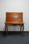 A late nineteenth century mahogany turn over topped tea table on cabriole legs