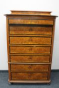 An antique continental walnut seven drawer chest