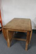 A blonde oak gate leg table