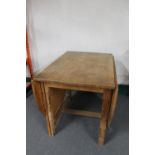 A blonde oak gate leg table