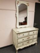 A painted traditional style four drawer chest, with matching mirror,