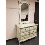 A painted traditional style four drawer chest, with matching mirror,