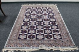 A Bokhara rug of compartmentalised design, on mint ground,