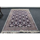 A Bokhara rug of compartmentalised design, on mint ground,