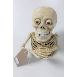 A cast iron skeleton novelty money box