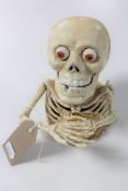 A cast iron skeleton novelty money box