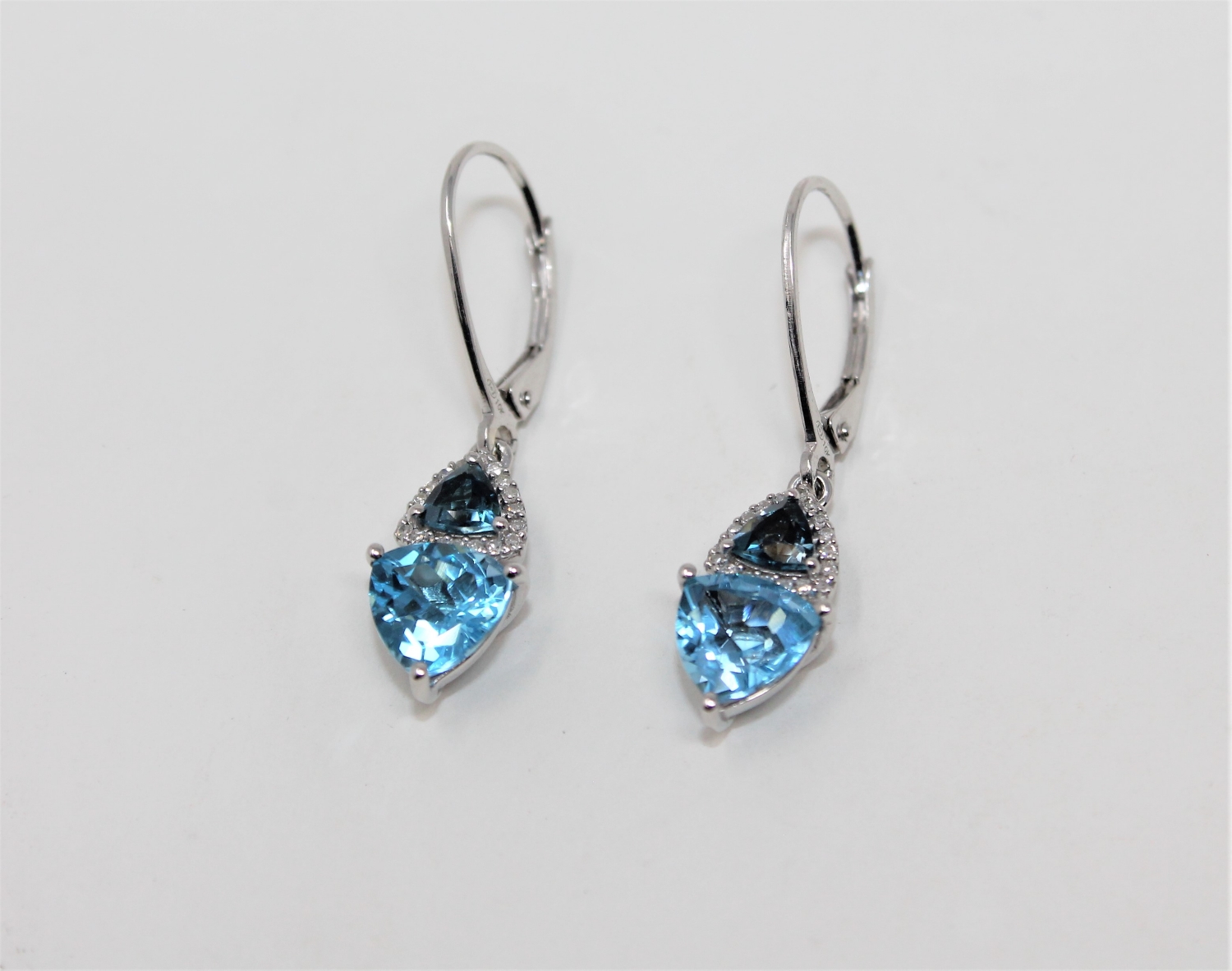 A pair of 10ct white gold blue topaz and diamond drop earrings,