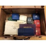 A leather suitcase containing British coin proof sets,