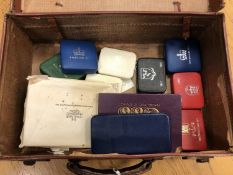 A leather suitcase containing British coin proof sets,