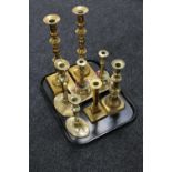 A tray of brass candlesticks,