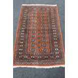 A Bokhara rug on red ground,