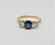 An 18ct gold sapphire and diamond three stone ring,