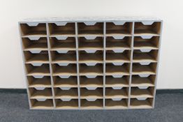 A set of painted 35-compartment pigeon hole shelves