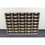 A set of painted 35-compartment pigeon hole shelves