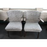 A pair of mid 20th century teak armchairs