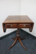 A mahogany flap sided occasional table