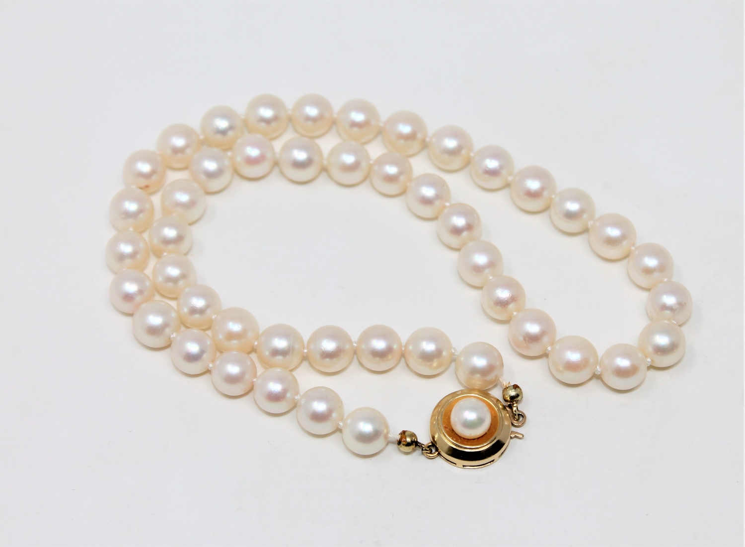 A continental cultured pearl necklace on 14ct gold pearl set clasp, length 35cm.