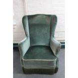 A mid 20th century wingback armchair