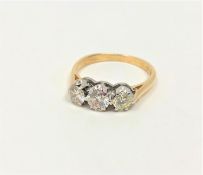 An 18ct gold three stone diamond ring, approximately 1 carat, size N.
