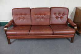 A mid 20th century Danish wood framed brown button leather settee
