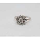 An 18ct gold diamond cluster ring, the principal brilliant-cut stone weighing approximately 0.