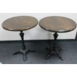 A pair of cast iron based bar tables