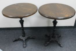 A pair of cast iron based bar tables