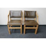 A pair of blond oak leather upholstered dining chairs