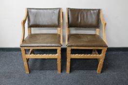 A pair of blond oak leather upholstered dining chairs