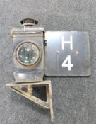 An early clear glass lens railway lamp on bracket and an enamelled railway sign "H4"