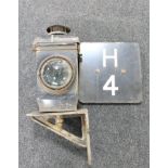 An early clear glass lens railway lamp on bracket and an enamelled railway sign "H4"