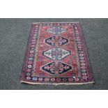 A Caucasian rug on pink ground,