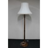 A stained beech standard lamp with shade