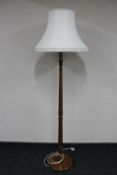 A stained beech standard lamp with shade
