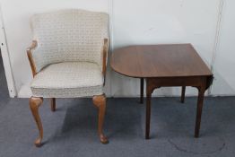 An Art Deco oak framed elbow chair and a flap sided table
