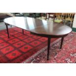 An oval 20th century dining table and two extension leaves