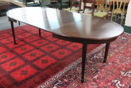 An oval 20th century dining table and two extension leaves