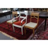 A painted antique armchair and pair of dining chairs