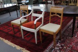 A painted antique armchair and pair of dining chairs