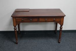 A Victorian mahogany two drawer writing desk CONDITION REPORT: 115cm wide by 53cm