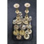 A tray of brass candlesticks and other brass ware