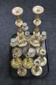 A tray of brass candlesticks and other brass ware