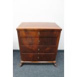 An antique mahogany four drawer chest on paw feet