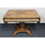 A continental mahogany library table fitted with a drawer on four-way pedestal